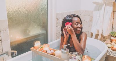 Woman being able to enjoy a warm bath after receiving financied services from Mr Perfect Plumbing