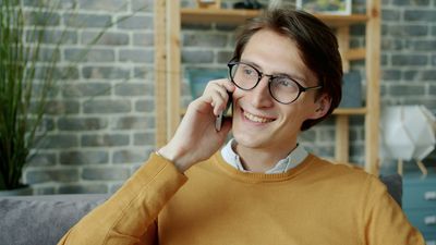 Young homeowner on the phone excitedly raving about Mr. Perfect Plumbing