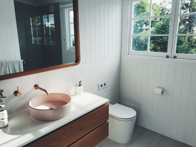 Plumber performing a plumbing inspection under a kitchen sink during a Perfect Care Club visit