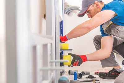 Licensed Mr Perfect Plumbing technician installing an in-wall toilet carrier system in a Denver home