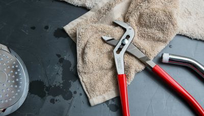 Plumbing wrench and chrome shower fixtures used by Mr Perfect Plumbing technicians in Denver