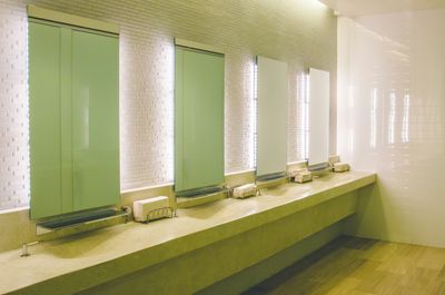 Commercial restroom with row of wall-mounted sinks requiring licensed plumbing services in Capitol Hill, Denver