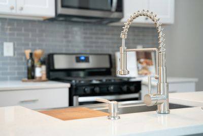 Modern kitchen with a commercial-style stainless spring faucet and undermount sink in a LoDo, Denver home
