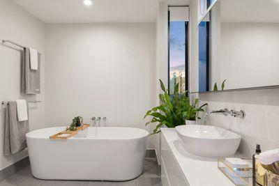 Modern bathroom with freestanding soaking tub and double vessel sinks in a Washington Park, Denver home