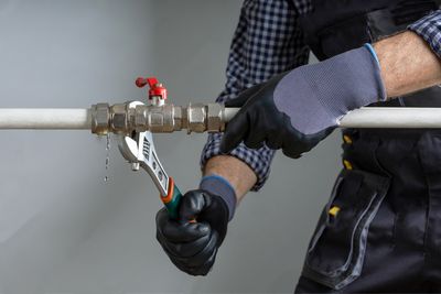 Plumber shutting off the main water valve during an Aurora plumbing emergency