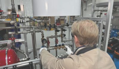 Mr Perfect Plumbing plumber diagnosing a commercial water heater