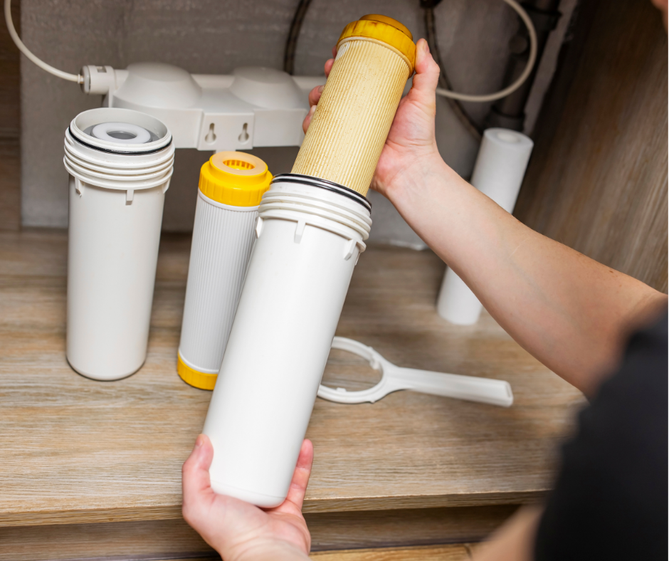 Person installing water filter underneath sink
